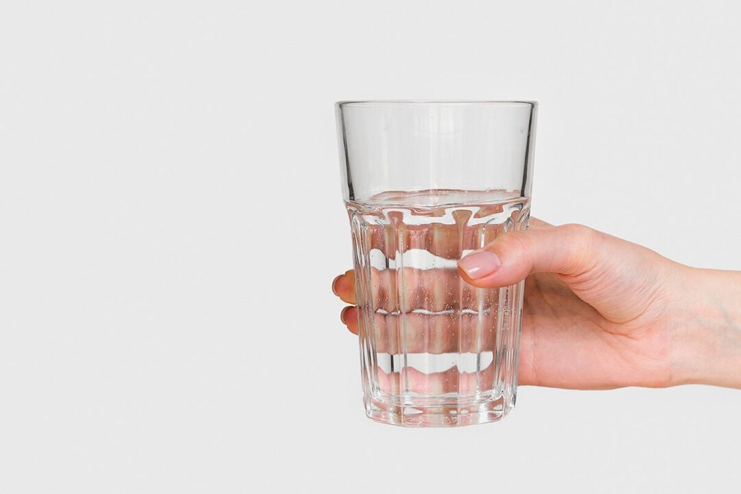 A glass of water with diluted powder ZXCVBNMQWTT